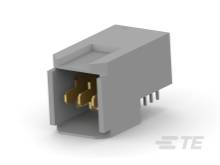Sivý elektronický konektor s viacerými zlatými kolíkmi vyčnievajúcimi z prednej strany.