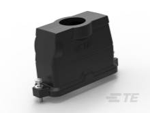 Čierna plastová súčiastka s obdĺžnikovou základňou a zaoblenými hranami, s otvorom hore. Slúži ako kryt alebo puzdro.