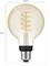 LED žiarovka so štandardným E27 päticou, vysoká 150 mm a s priemerom 95 mm, zobrazujúca špirálový žeravý vlákovec a označená nápisom 'Philips Hue'.