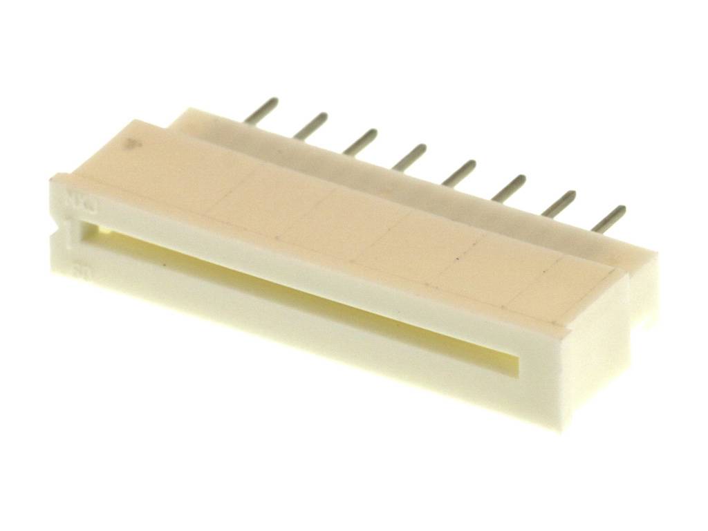 Biely, obdĺžnikový konektor s ôsmimi kovovými kolíkmi, ktorý sa používa na elektronické prepojenia, leží na svetlom povrchu.