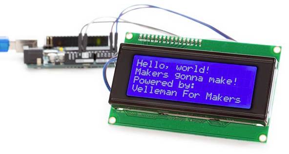 LCD displej zobrazuje správu 'Hello, world! Makers gonna make! Powered by: Velleman For Makers'. V pozadí je viditeľný elektronický obvod.