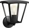 Čierna nástenná lampa so viditeľnou žiarovkou, ktorá vyžaruje teplé svetlo. Lampa má moderný, geometrický dizajn.
