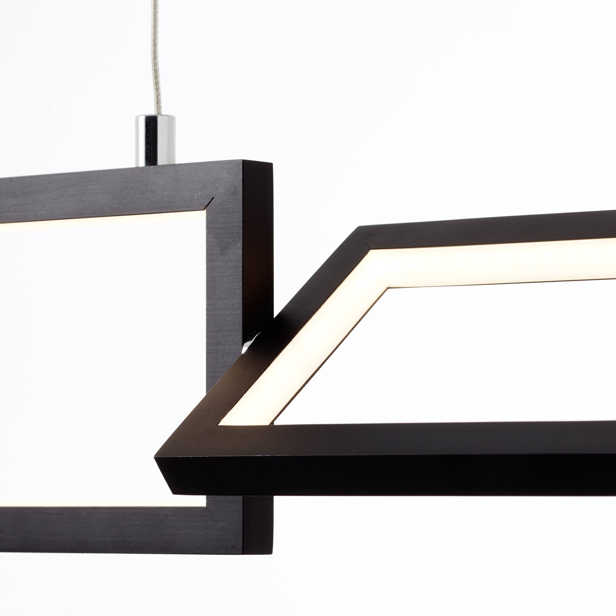 Moderná, obdĺžniková závesná lampa s čiernym rámom a integrovaným LED osvetlením, zavesená zo stropu.