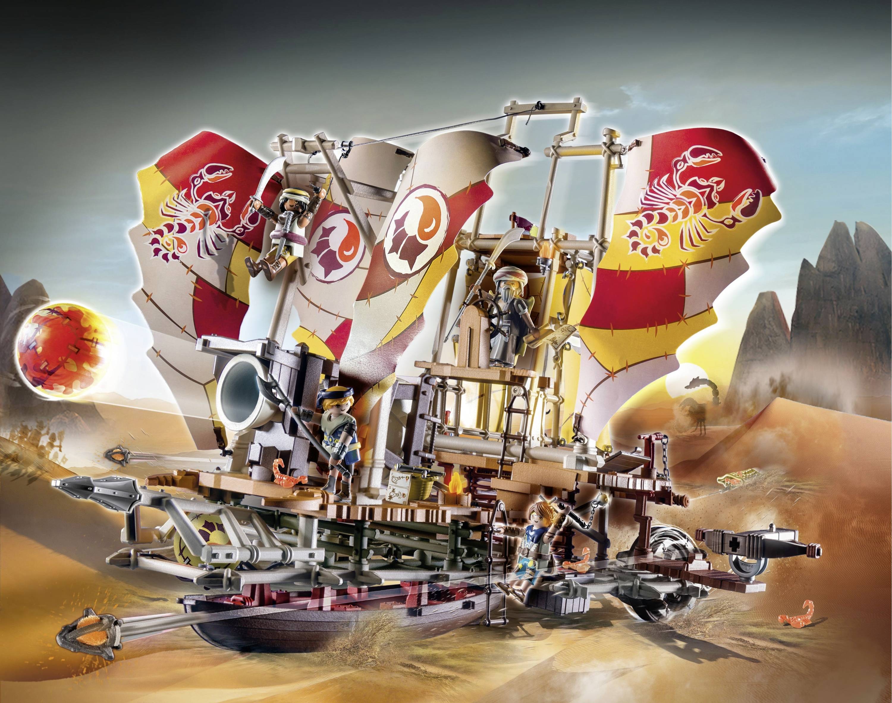Lego model púštneho vozidla s plachtami, obsadený figúrkami, jazdí cez púštnu krajinu s skalami a planétou.