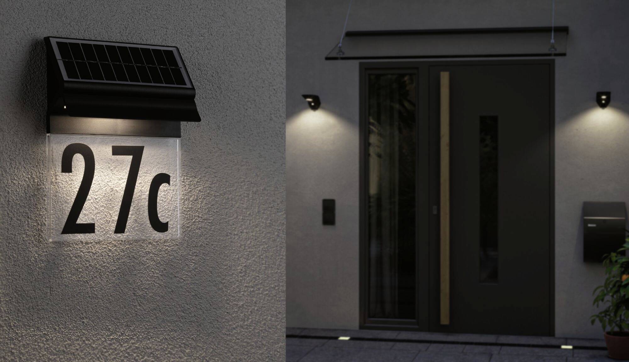 Domová tabuľka s číslom '27c', osvietená solárnym svietidlom, sa nachádza vedľa moderných vstupných dverí.