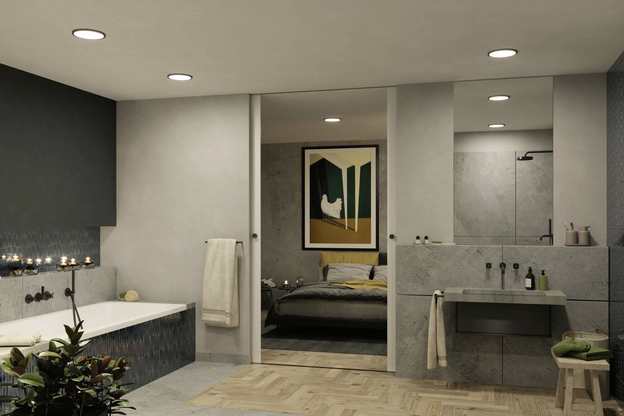Moderná kúpeľňa s vaňou a umývadlom z kameňa, ktorá sa otvára do spálne s umením na stene. Teplé osvetlenie.
