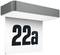 Označenie budovy s číslom '22a' čiernym písmom na bielom pozadí pod sivým, obdĺžnikovým rámom.