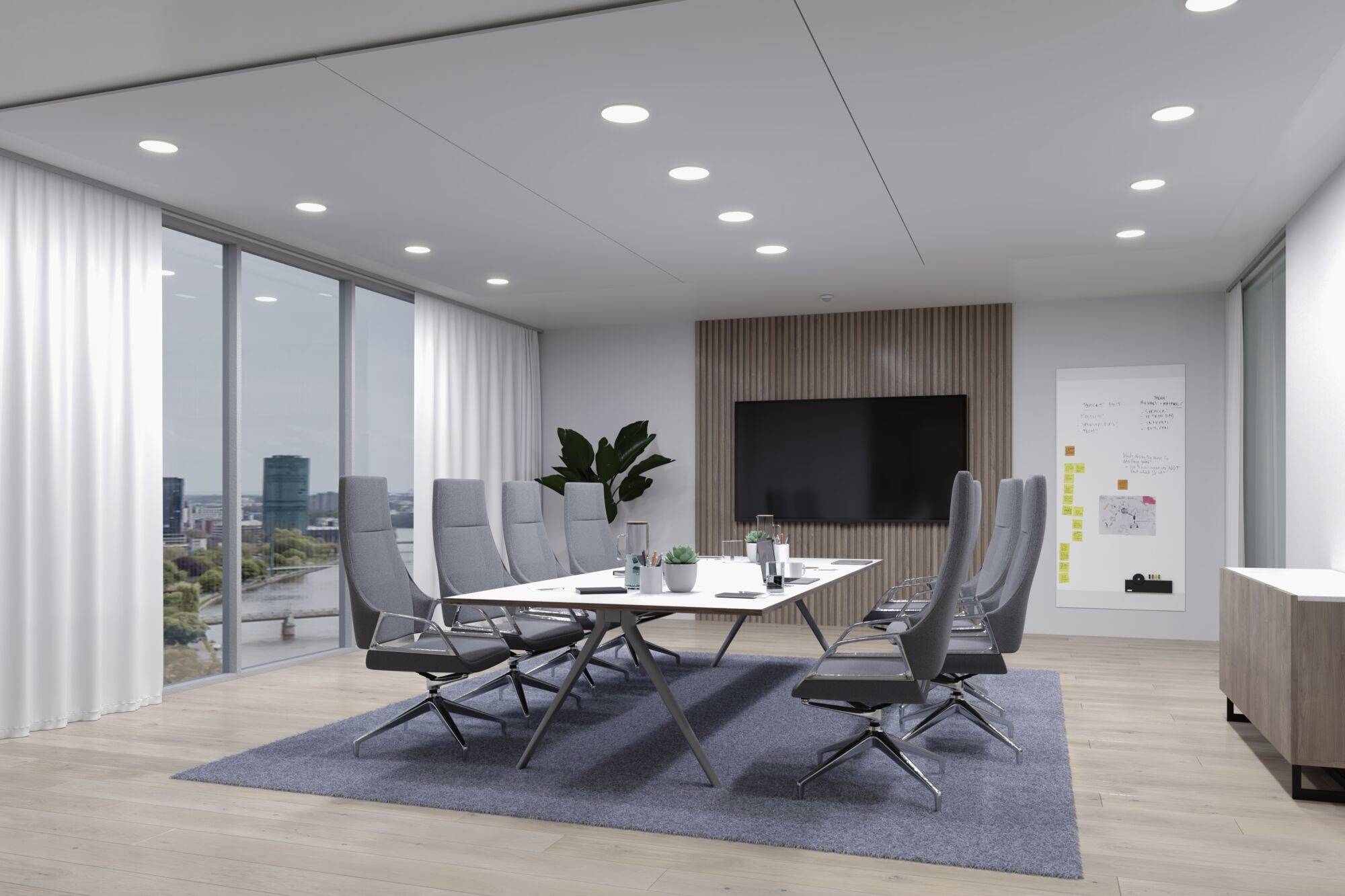 Moderná konferenčná miestnosť s veľkým stolom, ôsmimi stoličkami, plochou obrazovkou na stene, tabuľou a veľkými oknami s výhľadom.