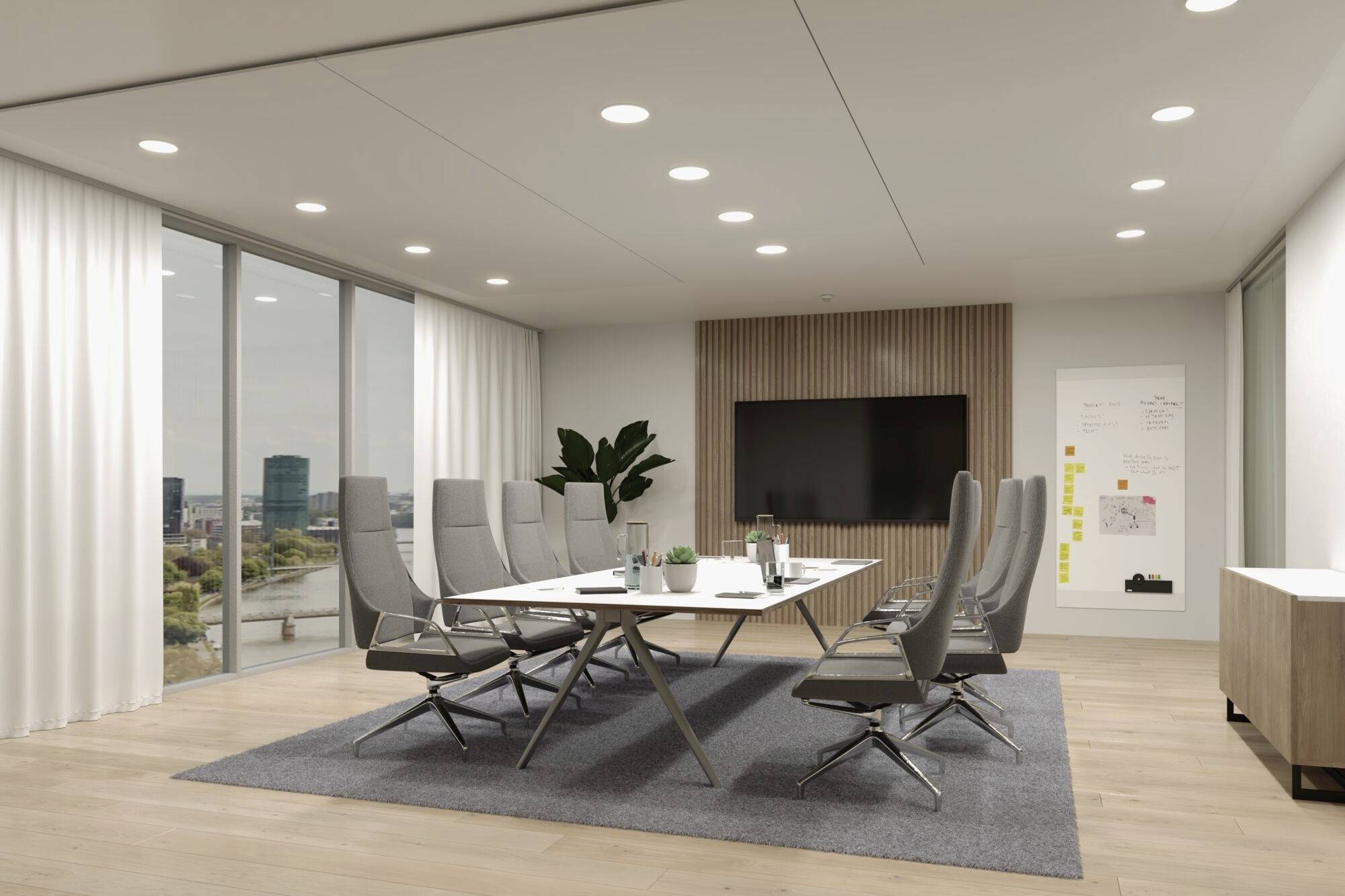 Moderná konferenčná miestnosť s veľkým stolom, obklopená ôsmimi sivými stoličkami. Veľká obrazovka na stene s výhľadom na okná.