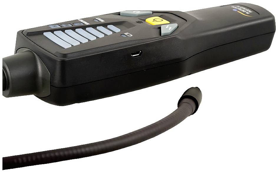 Čierne ručné zariadenie s viacerými tlačidlami a flexibilnou hadicou. Vyzerá ako špeciálny nástroj alebo meracie zariadenie.
