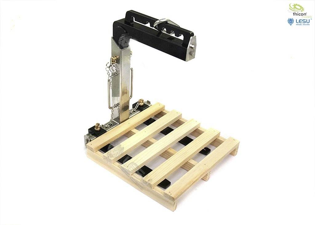 Miniaturná paletová manipulačná plošina z kovu a dreva ukazuje, ako sa palety zdvíhajú a premiestňujú v skladových priestoroch.