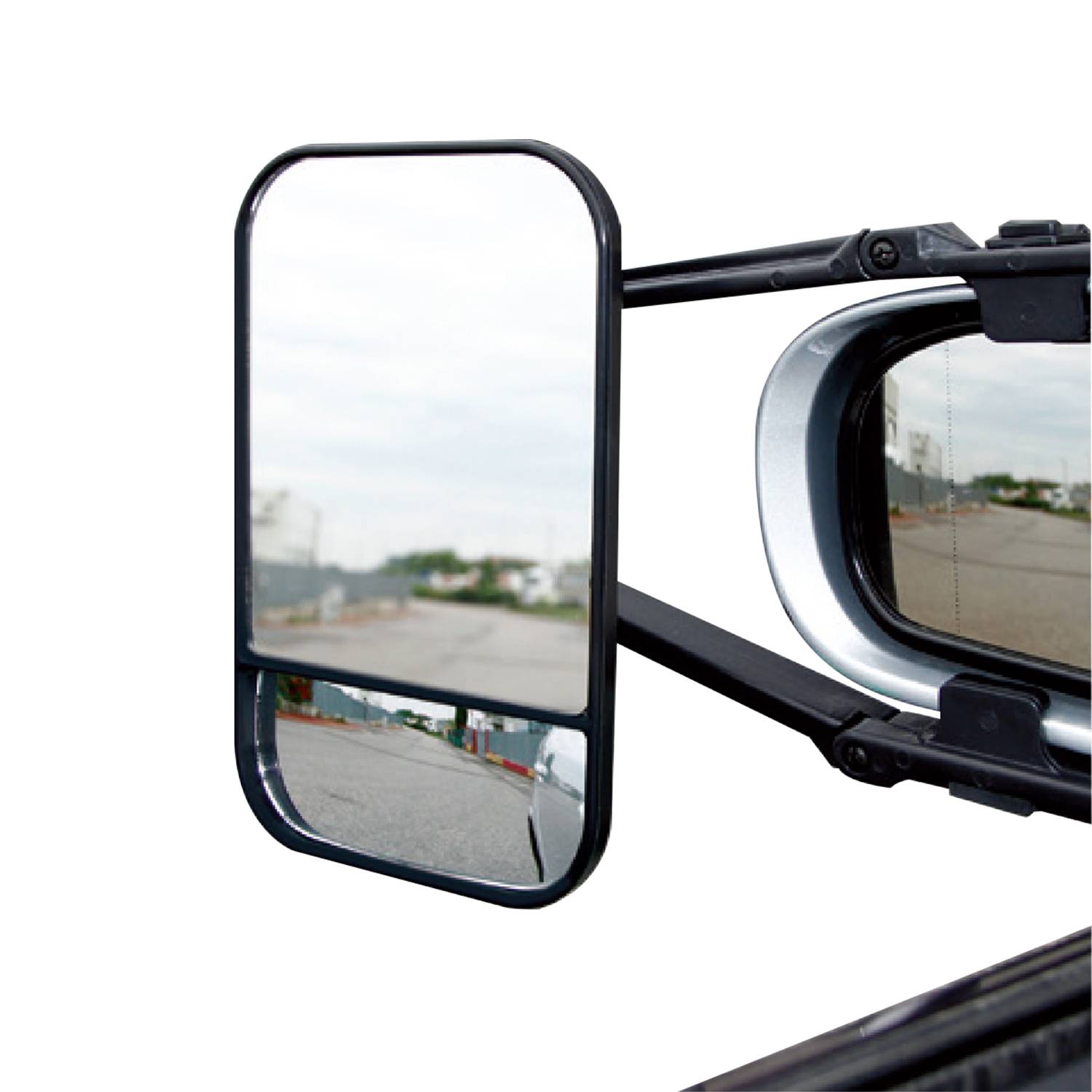 Bočné zrkadlo nákladného automobilu, ktoré zobrazuje prevrátenú panorámu cesty a okolitého prostredia.