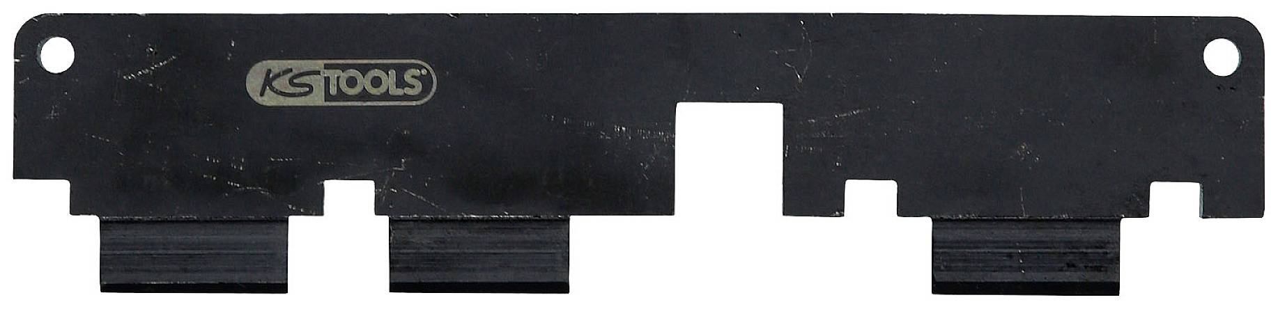 Čierna plastová súčiastka s viacerými výrezmi a logom 'KS TOOLS'. Má dva okrúhle otvory v rohoch.