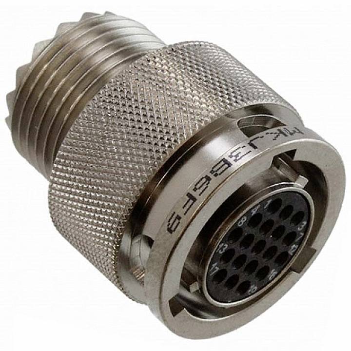 Kovový valcovitý elektrický konektor s viacerými kolíkmi a vrúbkovaným povrchom pre lepšiu manipuláciu.