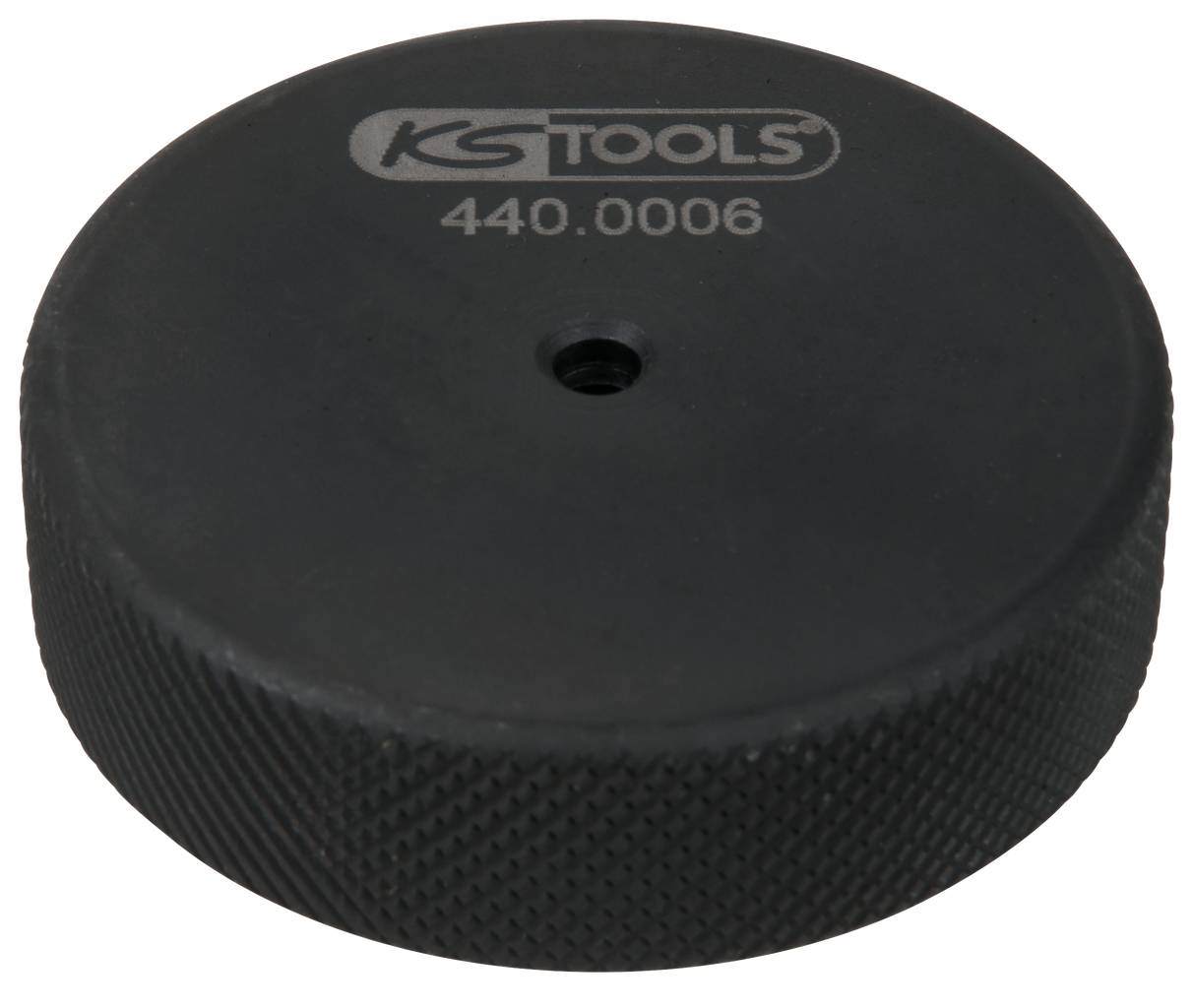 Guľatý nástroj od KS Tools s nápisom '440.0006', čierny materiál, drsne štruktúrovaný povrch, centrálny otvor.