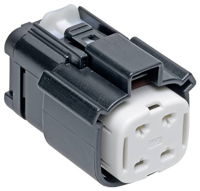 Zblízka pohľad na čierny a biely elektrický konektor s obdĺžnikovým tvarom a viacerými otvormi pre vodiče.