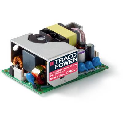 Otvorený elektronický napájací zdroj s komponentmi ako transformátor, kondenzátory a cievky. Označenie 'TRACO POWER' na červenej etikete.