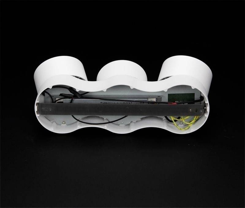 Biele, oválne zariadenie s troma komorami, ktoré odhaľuje elektronické komponenty a káble vo svojom vnútri, umiestnené pred čiernym pozadím.