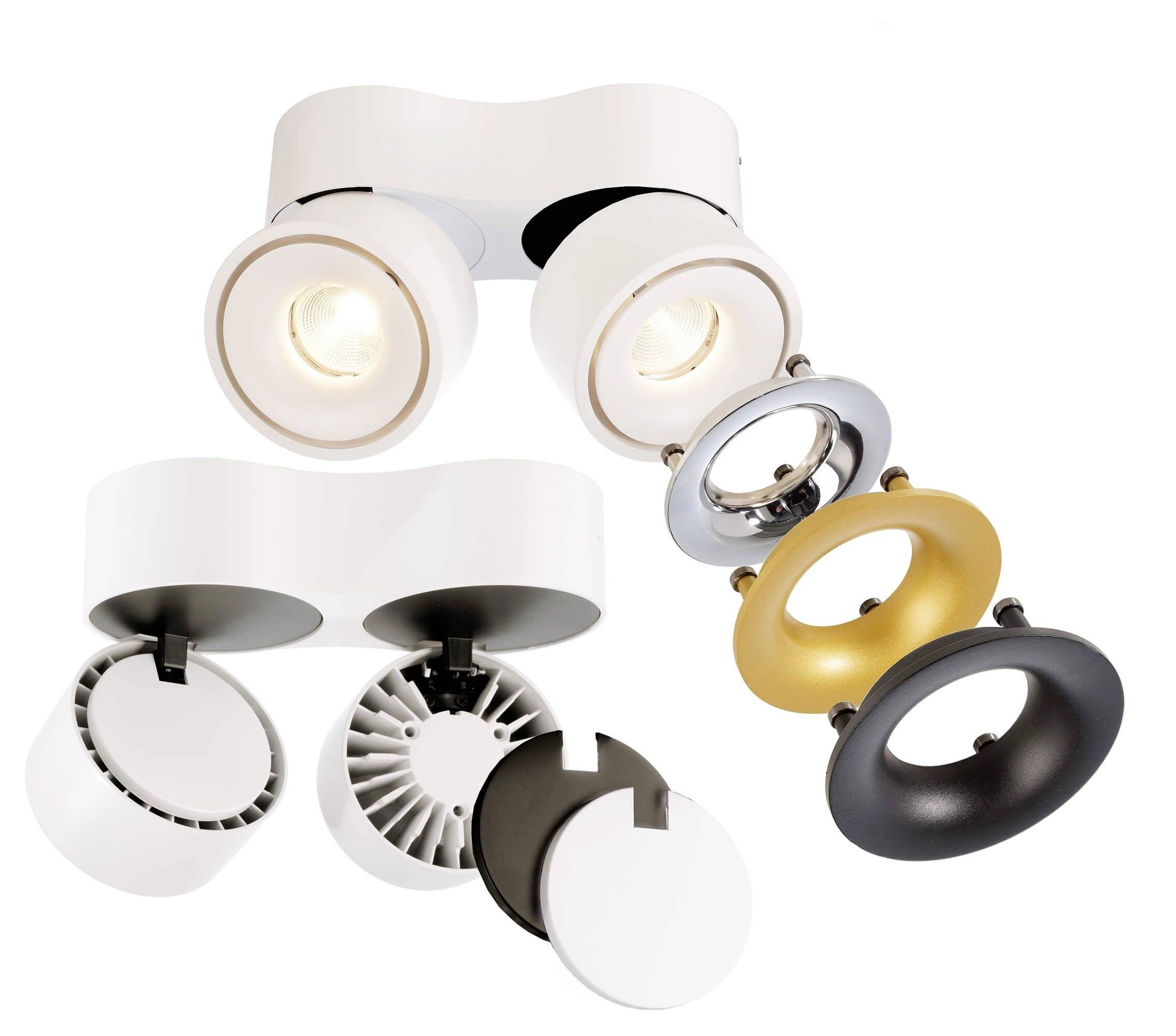 Dve moderné, okrúhle stropné lampy s rôznymi odnímateľnými krytmi v bielej, zlatej a čiernej farbe, ktoré ukazujú flexibilitu v dizajne.