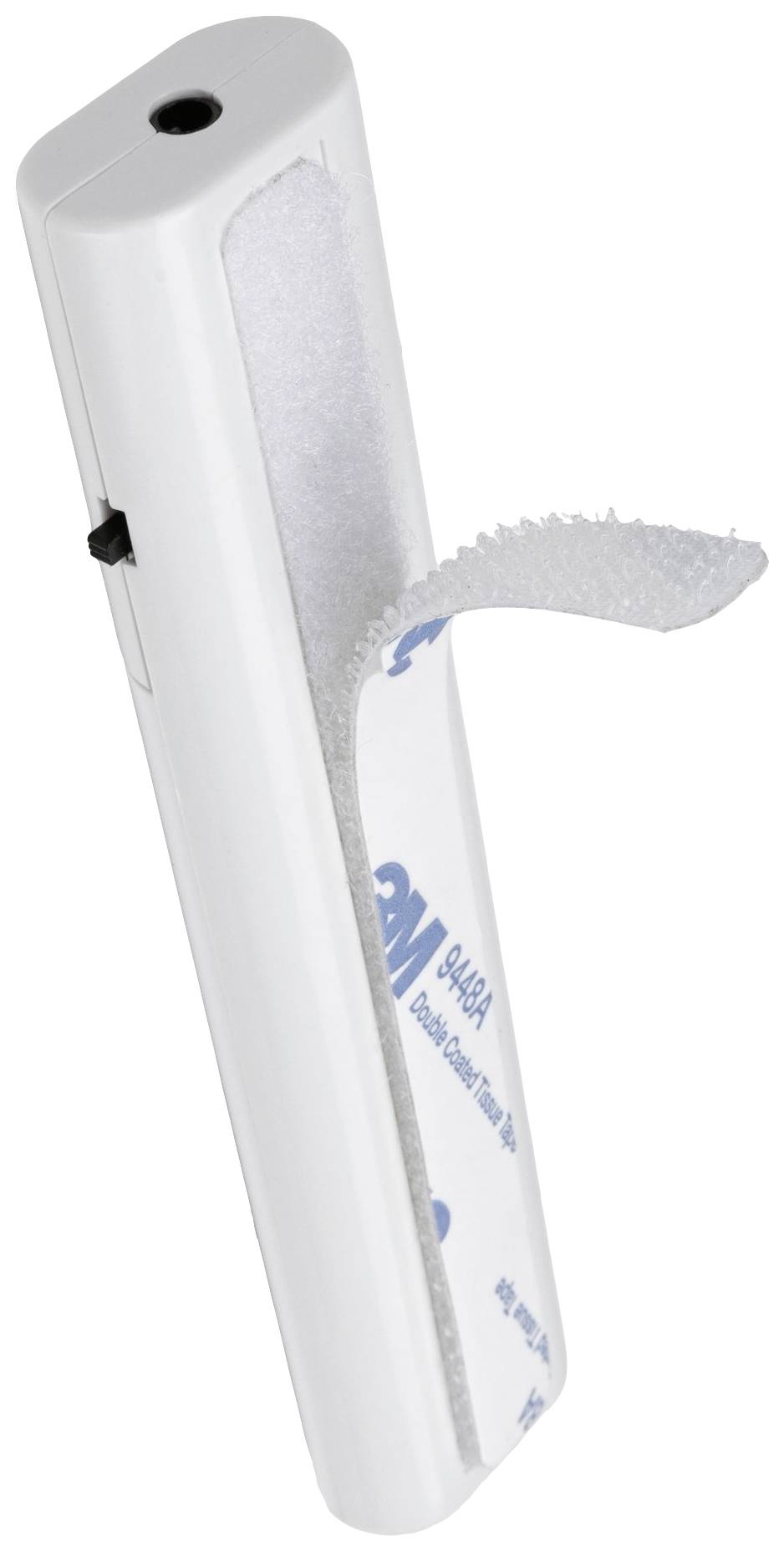 Biely plastový klip so suchým zipsom, vľavo prepínač.