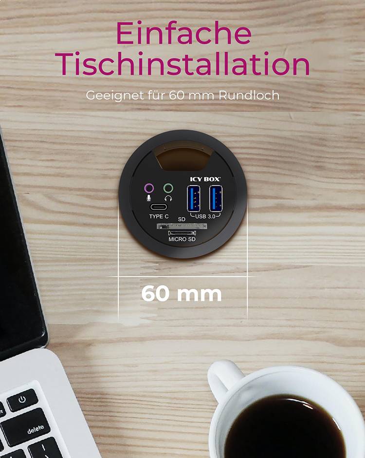 Zabudovaný USB hub do dosky stola s konektormi Typ-C, USB 3.0 a Micro SD, vhodný pre 60 mm okrúhly otvor. Vedľa notebook a šálka kávy.