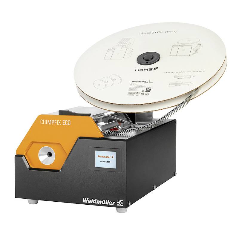 Krimpovacie zariadenie od spoločnosti Weidmüller, model 'Crimpfix Eco'. Zariadenie je kompaktné, s páskovou mechanikou na vrchu. Navrhnuté v Nemecku.