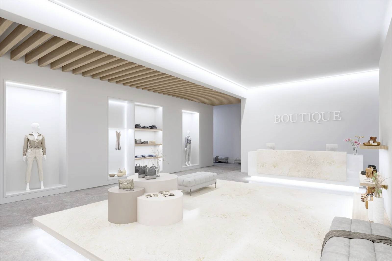 Moderný butikový obchod s minimalistickým interiérom, bielymi stenami, elegantným osvetlením a vystavenými kusmi oblečenia.