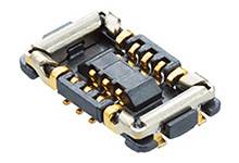 Čierno-zlatý elektrický konektor s viacerými kontaktnými bodmi, používaný na prepojenie elektronických komponentov.