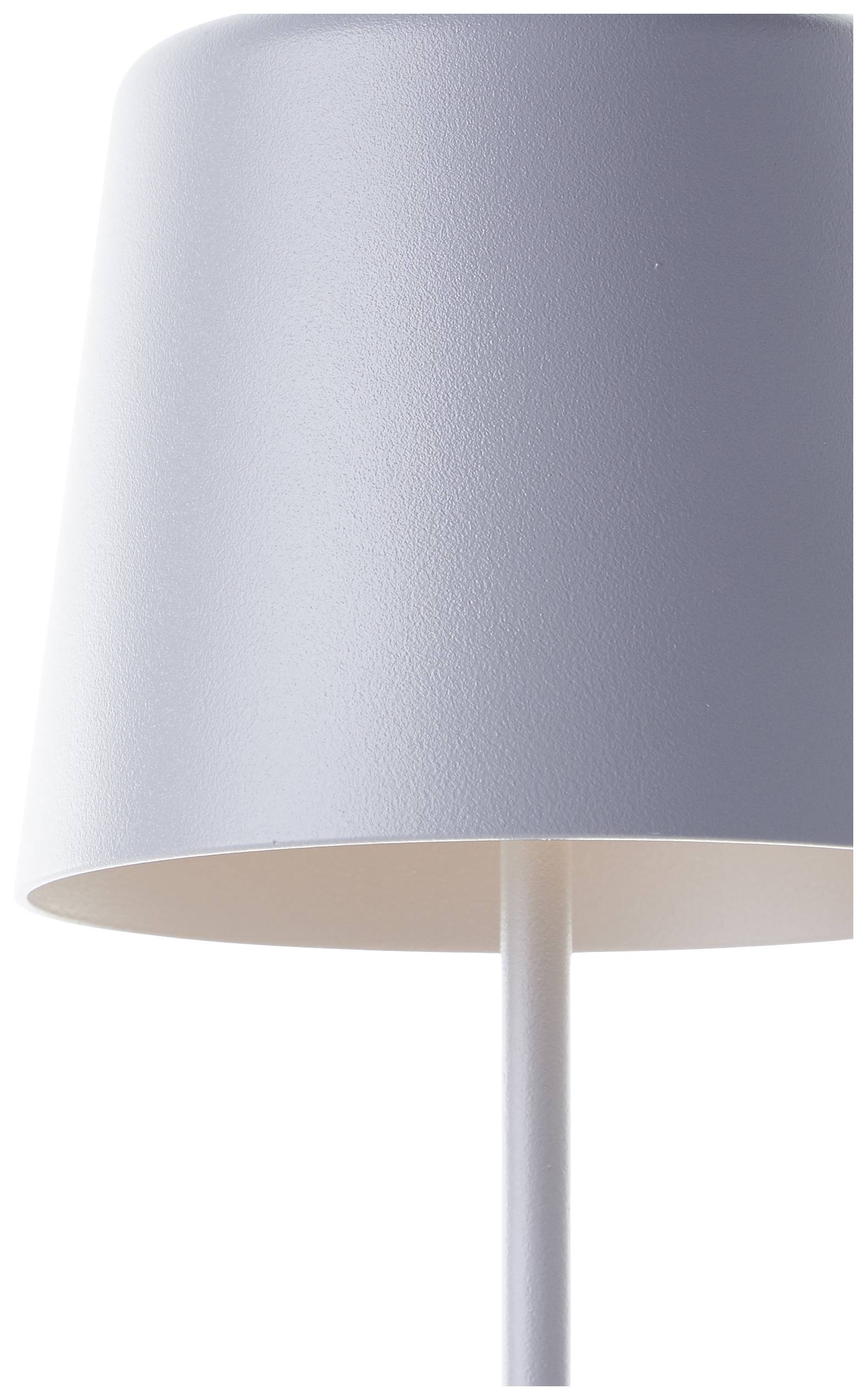 Biela, moderná stolná lampa s úzkym stĺpikom a kónicky tvarovaným tienidlom. Jednoduché dizajnové riešenie vhodné pre minimalistický interiér.