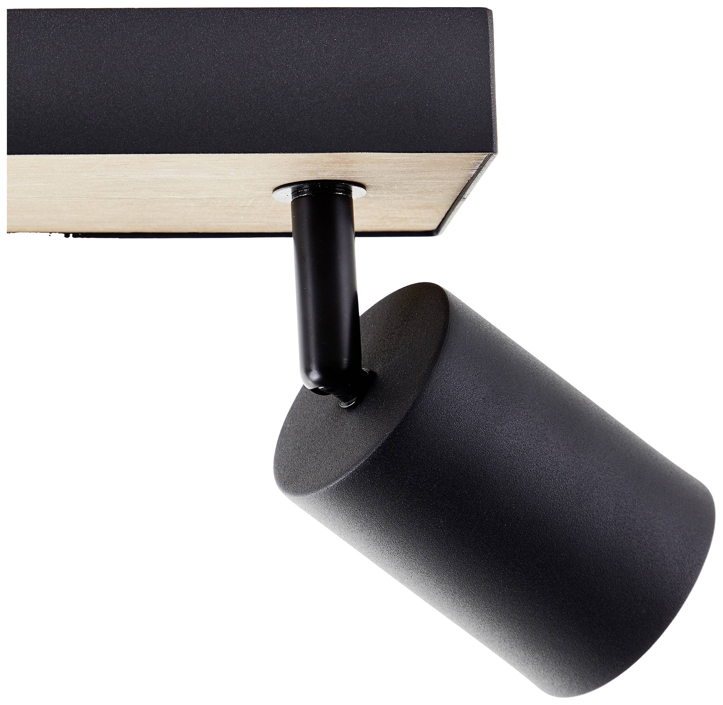 Čierny stropný reflektor s valcovitým tienidlom, namontovaný na drevenej doske. Tienidlo je nakláňené smerom nadol.