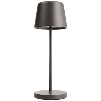 Moderná stolná lampa s valcovitým tmavým tienidlom na štíhlej tyči a kruhovej základni.