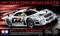 Automobílový model Mercedes-Benz CLK-GTR z roku 1997: Model auta značky Tamiya v mierke 1:10, striebornej farby s pretekárskym dizajnom, dodávaný v obale s technickými detailmi.