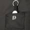 Čierny textil s malým vreckom, ktoré drží kľúčenku s čiernym príveskom. Vrecko zobrazuje štylizovaný symbol.