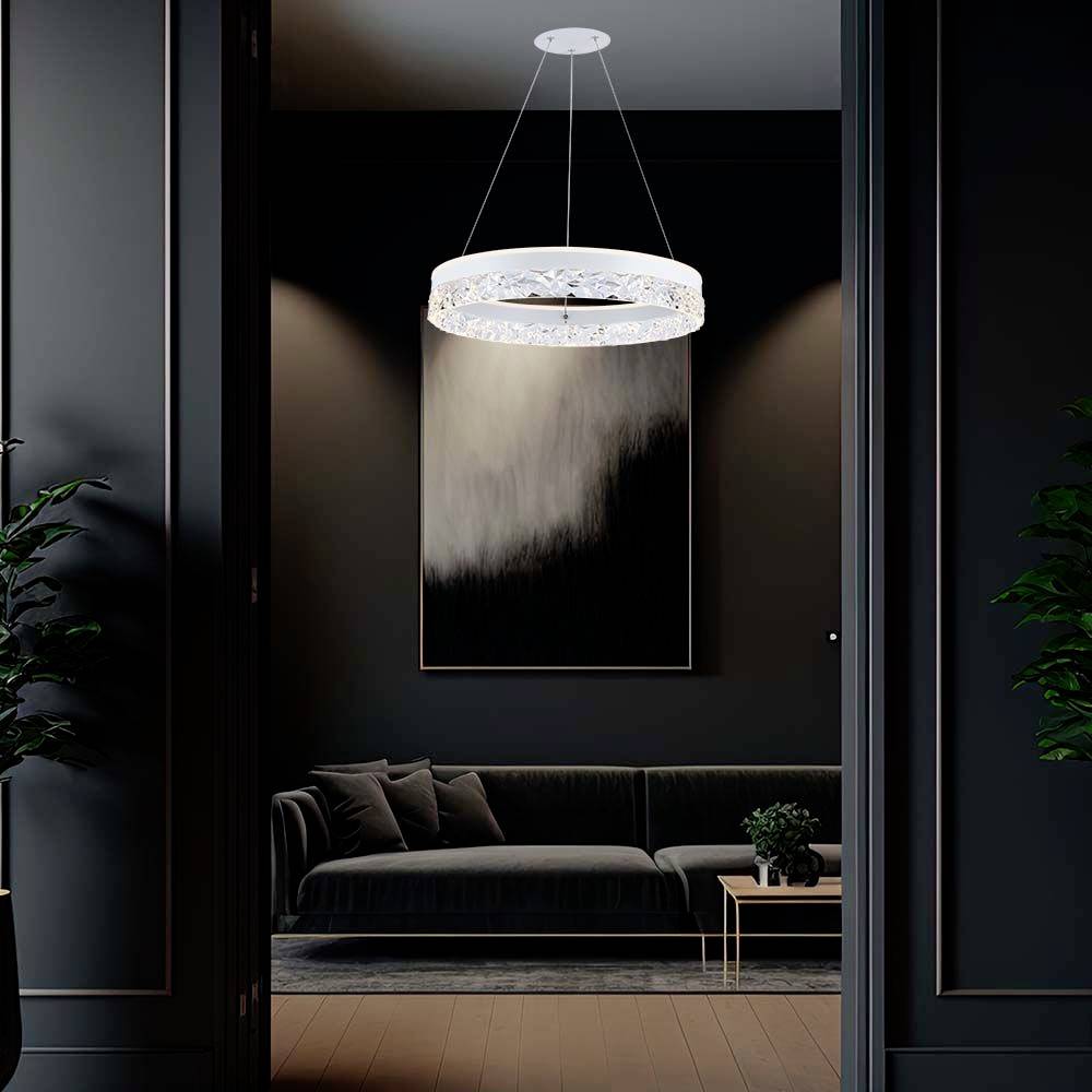 Moderná obývačka s čiernou sedačkou a konferenčným stolíkom. Štýlová závesná lampa osvetľuje abstraktný obraz na stene.