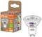LED žiarovka OSRAM vedľa jej obalu. Obal zobrazuje energetickú triedu A, výkon 3,3 W, svietivosť 600 lm, teplá biela.