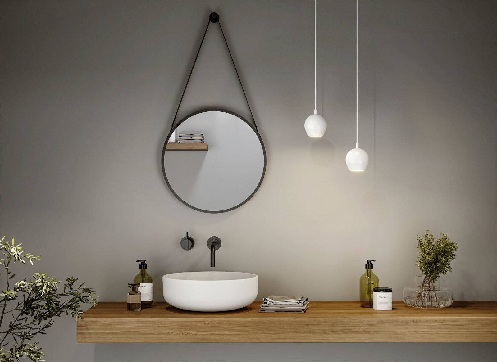 Moderná kúpeľňa zobrazuje okrúhle zrkadlo nad drevenou poličkou s bielym umývadlom. Dva závesné svietidlá osvecujú priestor.