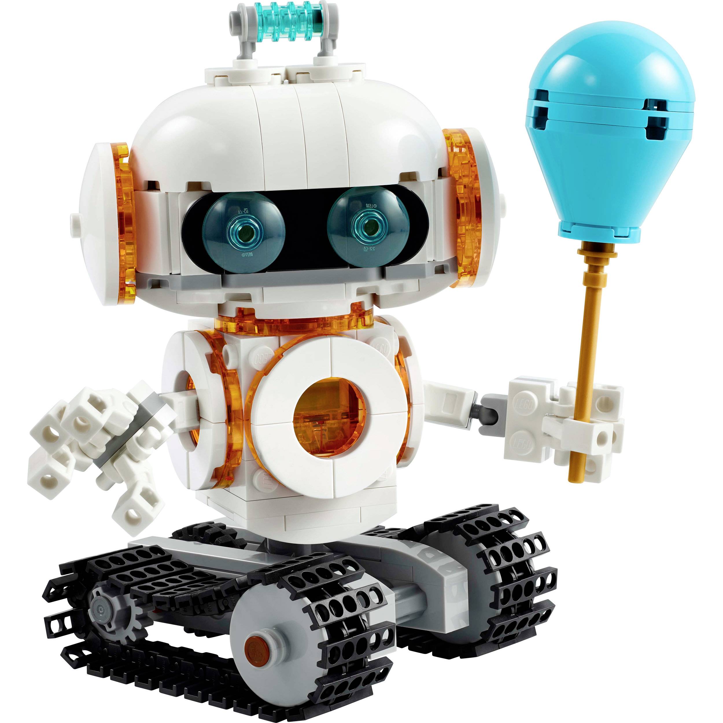 Malý robot z modulových dielov s oranžovými akcentmi drží v pravej ruke modrý balón a stojí na reťazových kolieskach.