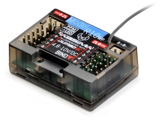 Čierny elektronický prijímač s káblom a viacerými slotmi, označený ako 'Model R10', určený pre diaľkové ovládacie systémy.