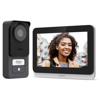 Videovrátnik s displejom zobrazuje ženu, ako sa usmieva vonku; zariadenie od Philips s názvom 'Baker Family'. Integrácia dohľadu a komunikácie.