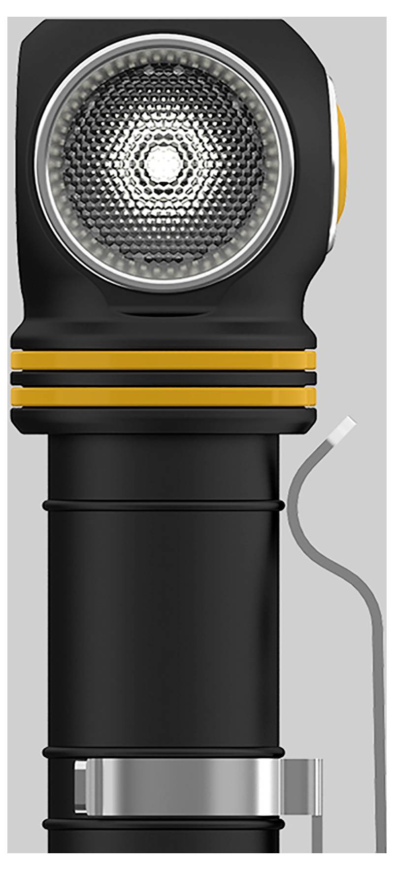 Čierna baterka so žltými pruhmi a káblom po boku. Je zobrazená vo zvislej polohe a ukazuje hlavu lampy so svetelným filtrom.