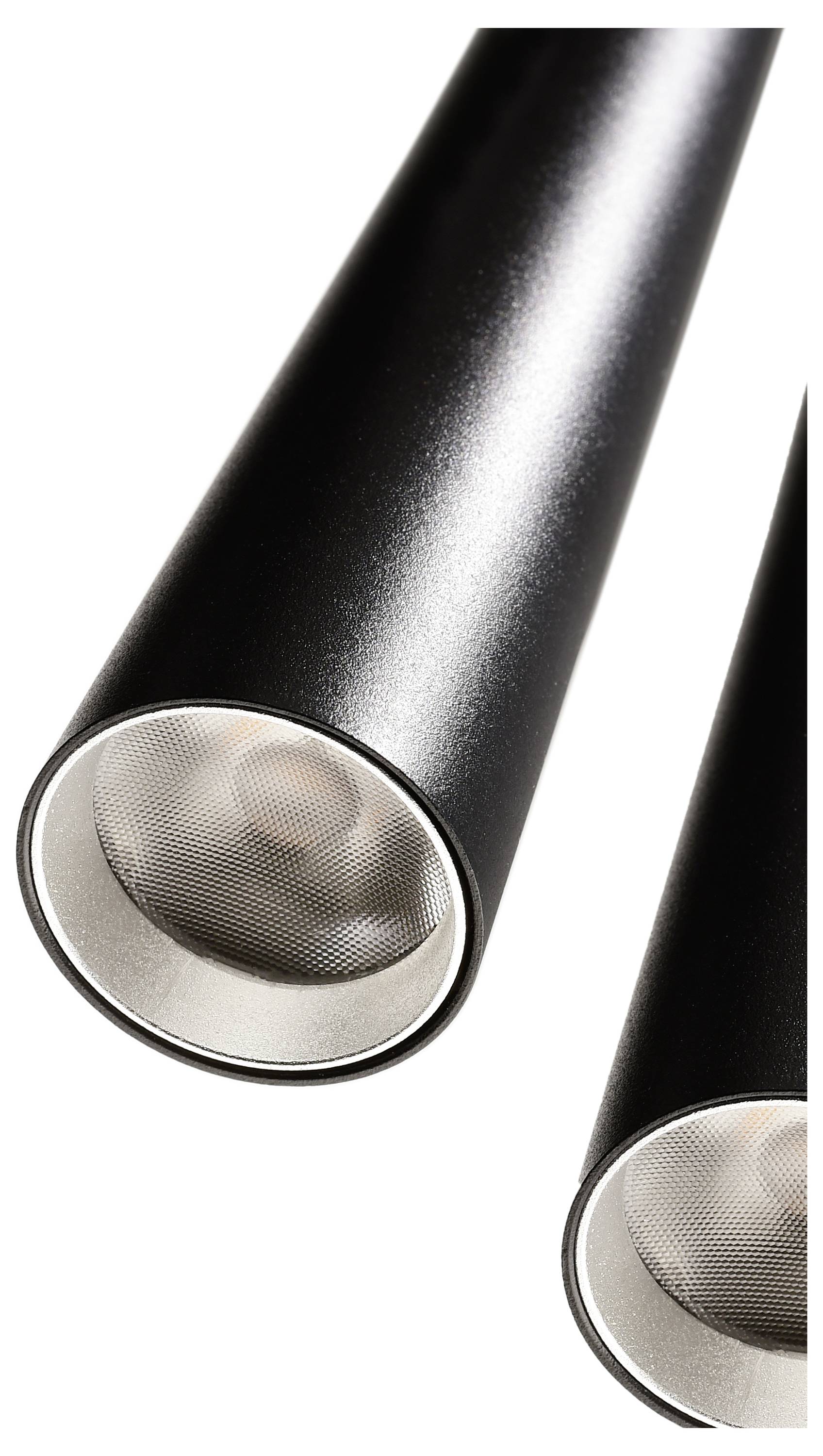 Čierne valcovité lampy s kovovými okrajmi, zobrazené v detailnom zábere pred bielym pozadím.