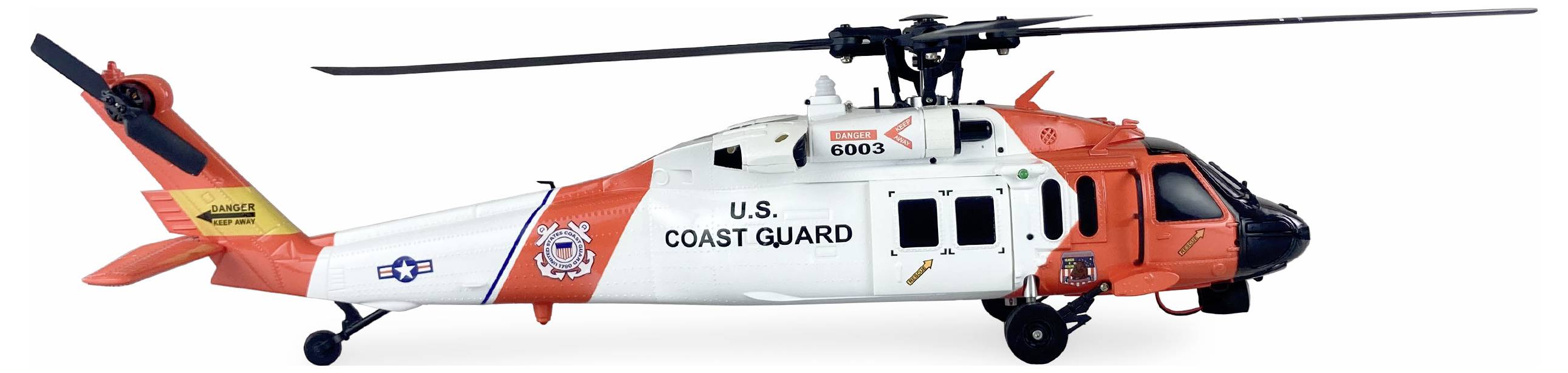 Vrtuľník pobrežnej stráže USA s oranžovo-bielym náterom a rotujúcimi listami vrtule, pohľad z boku.
