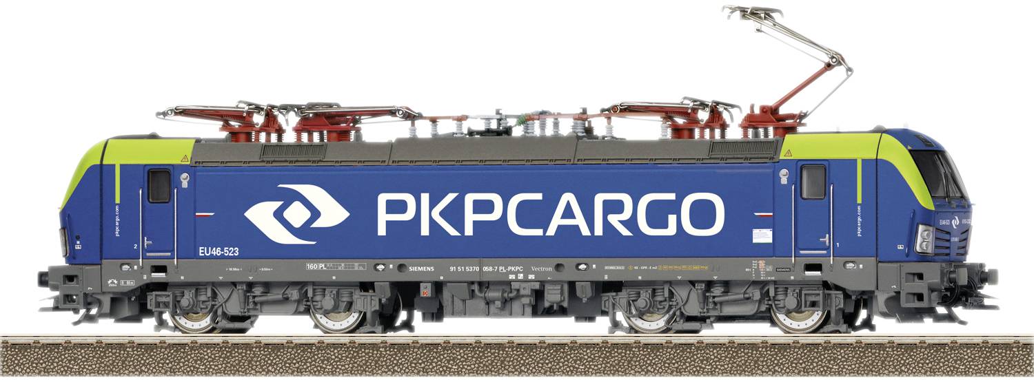 Modrý nákladný vlak spoločnosti 'PKP Cargo' na koľajniciach, s zelenými a červenými akcentmi. Elektrické trakčné vedenie je pripojené.