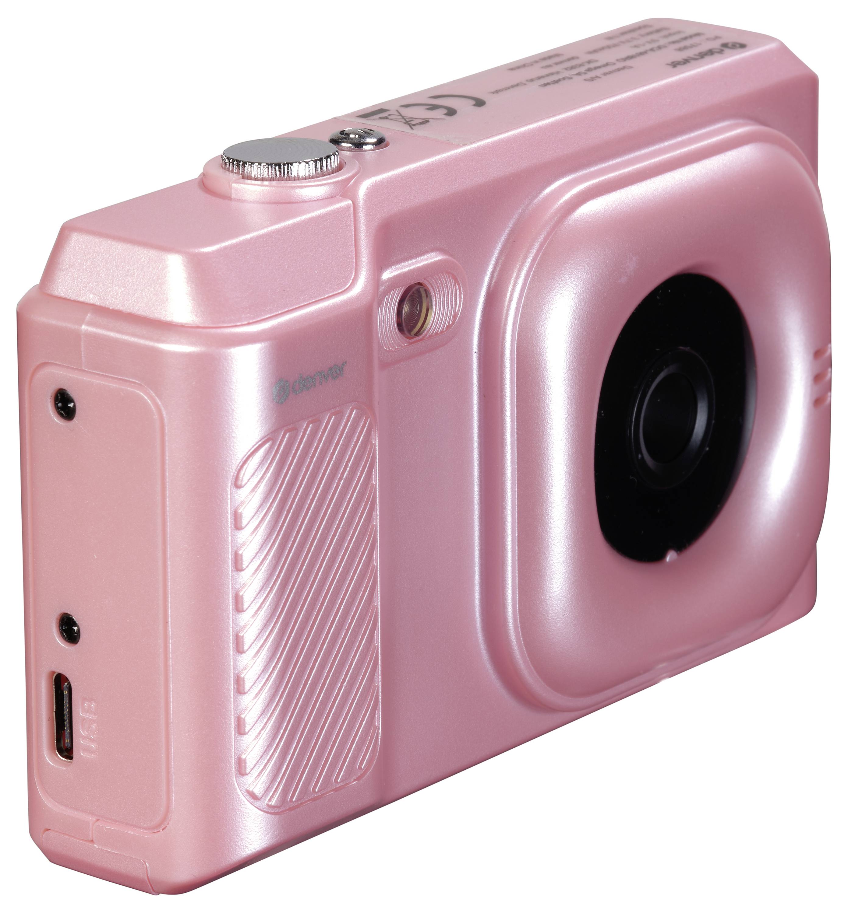 Ružový digitálny fotoaparát s hladkým povrchom a veľkým objektívom, pohľad z boku.