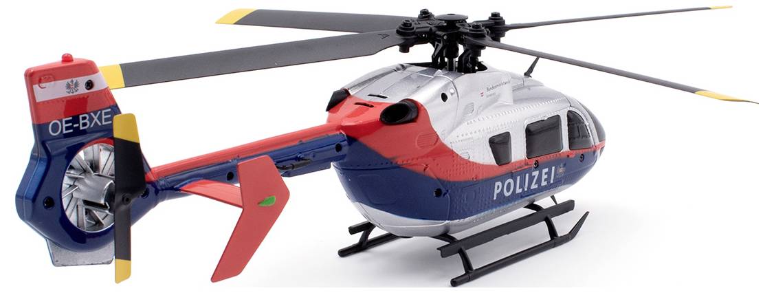 Modelový vrtuľník s nápisom 'POLÍCIA', prevažne modro a červeno sfarbený, so žltými akcentmi na vrtuľových listoch.