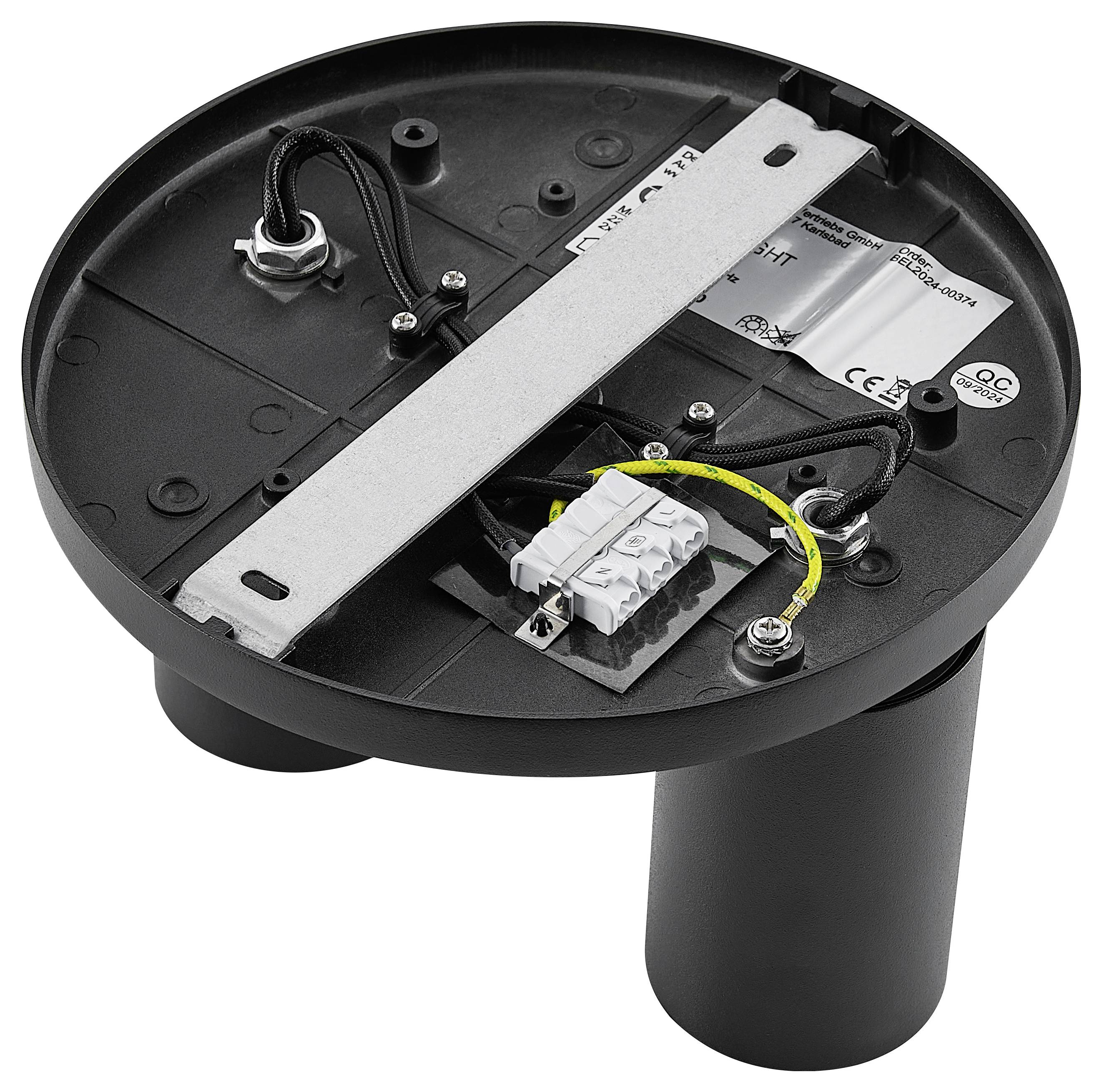 Čierny, guľatý kryt s elektronickými komponentmi a káblami vo vnútri. Používaný najmä pre elektrotechnické inštalácie.