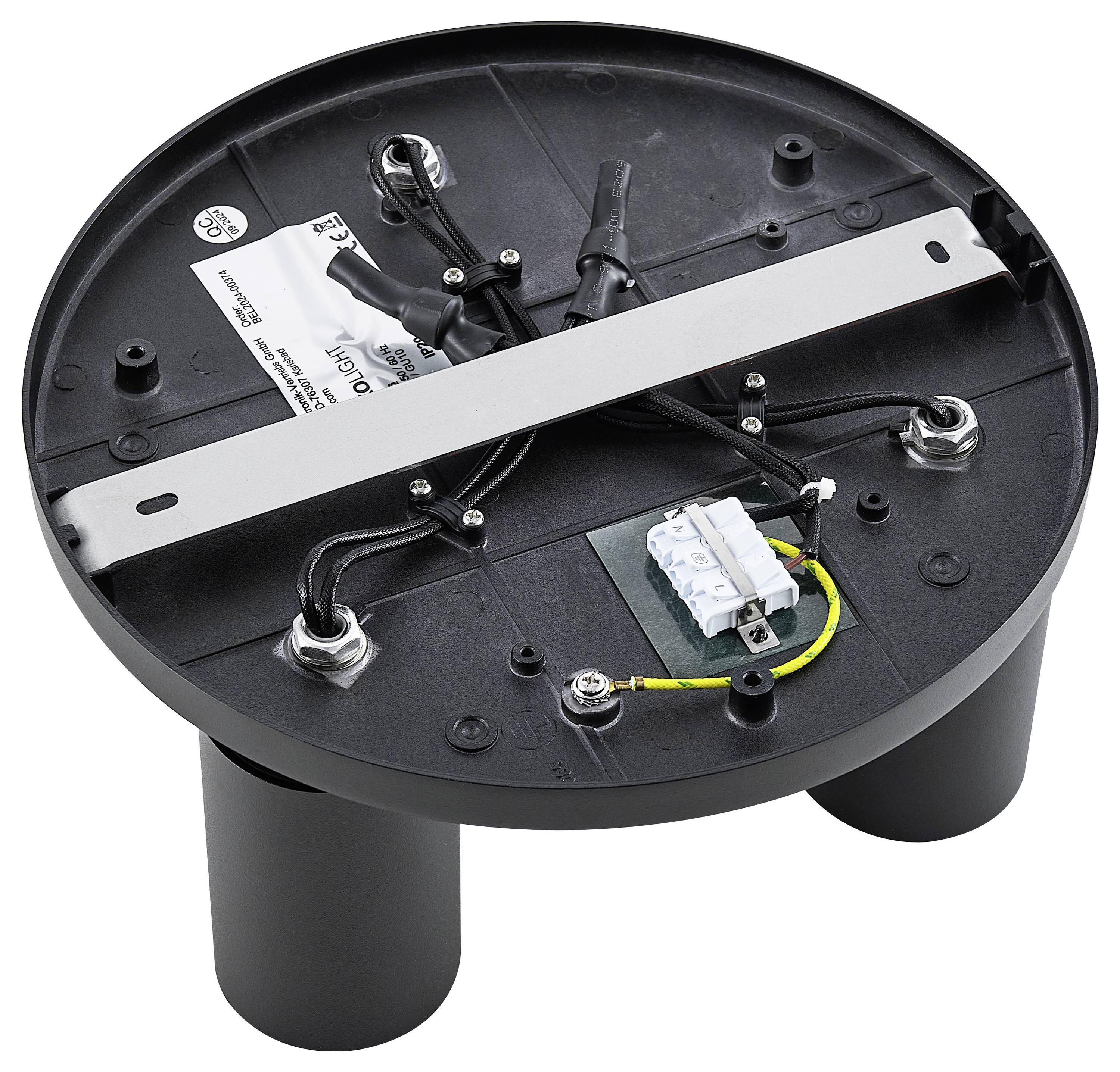 Guľatý kryt odhaľuje vnútornú stranu elektrického zariadenia s káblami, svorkami a namontovanou lištou.