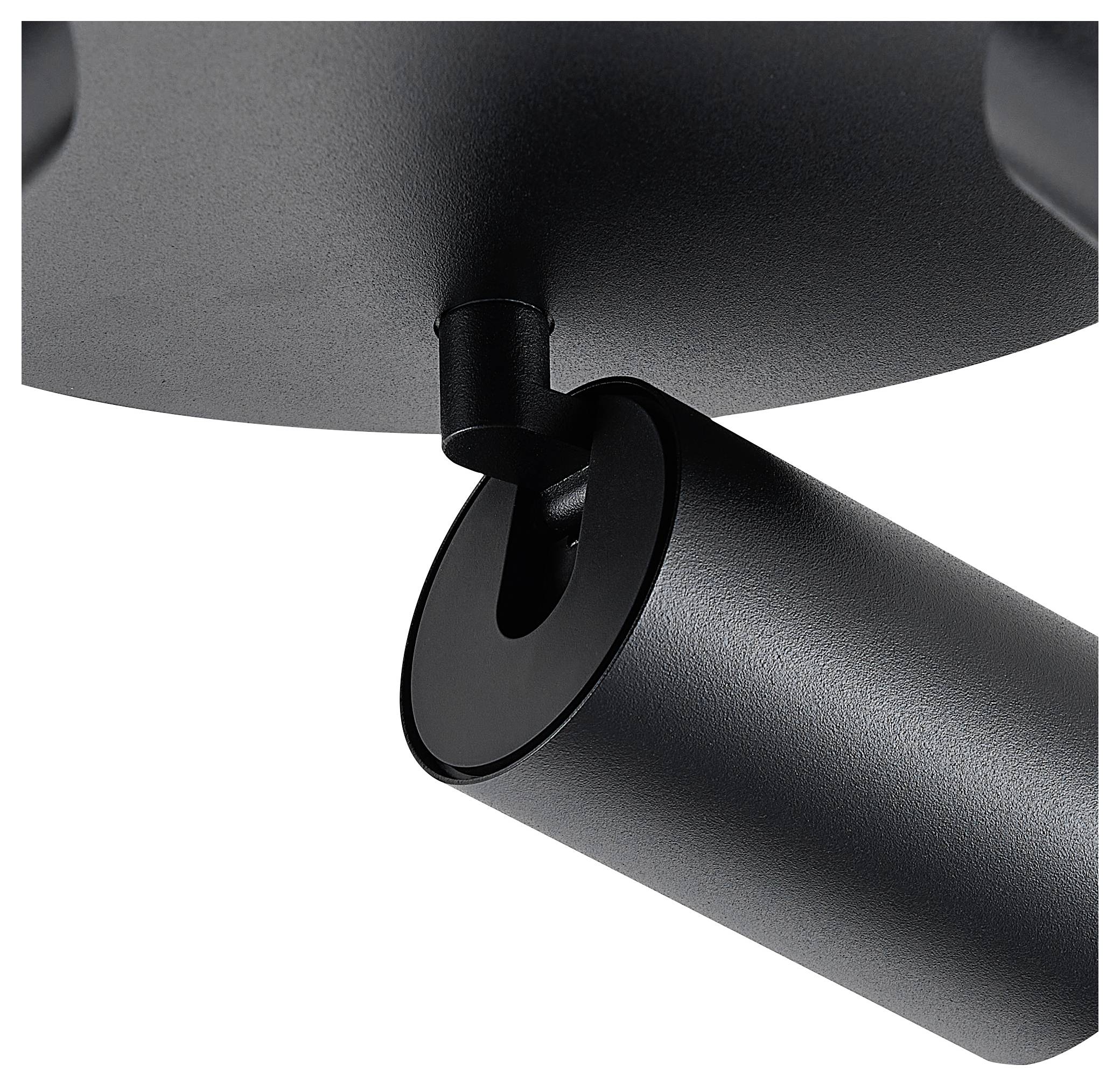 Detailný záber čierneho valcovitého kĺbu na lampe. Kĺb spája základňu s pohyblivým ramenom.