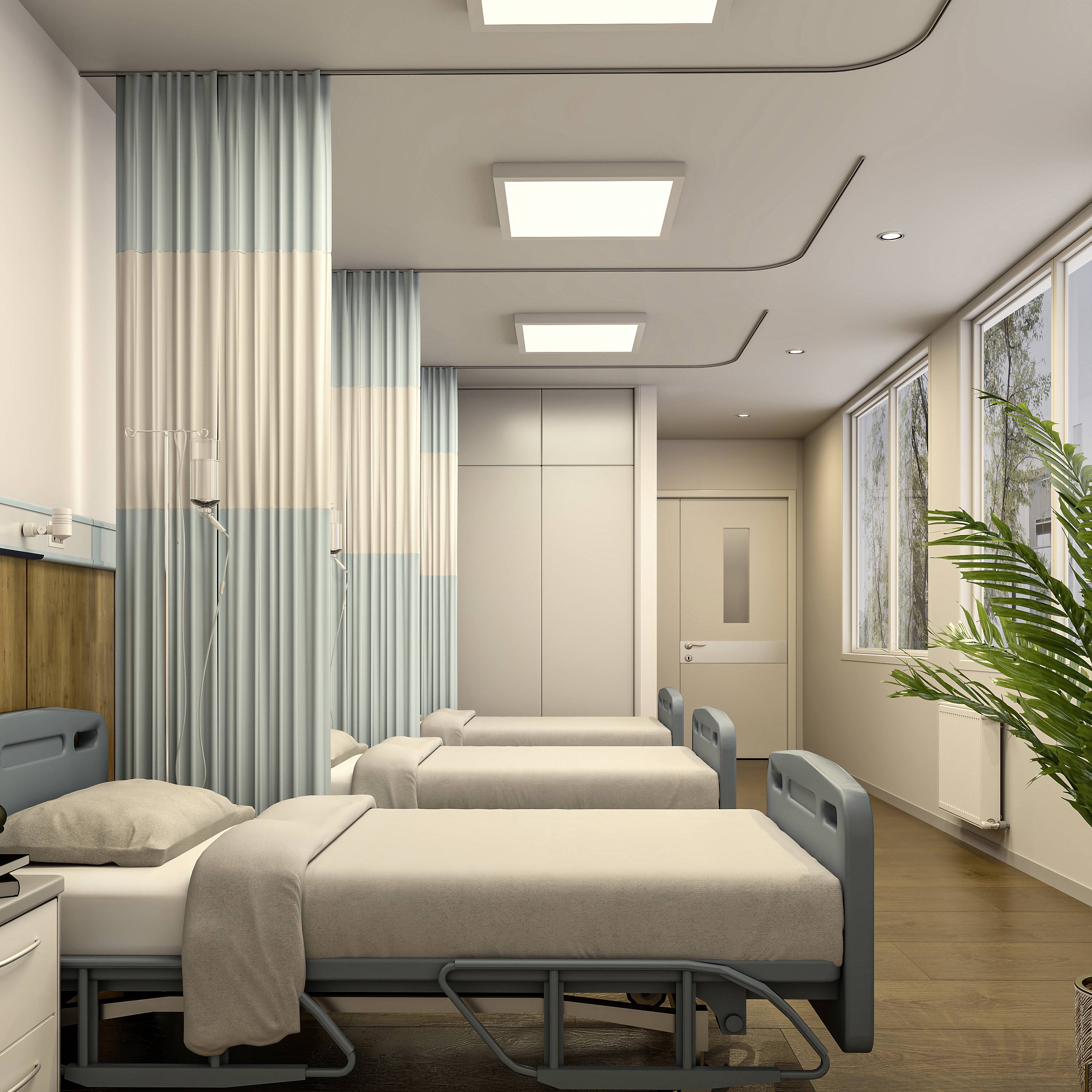 Moderná nemocničná izba s niekoľkými prázdnymi posteľami, záclonami a veľkými oknami, ktoré prepúšťajú prirodzené svetlo.