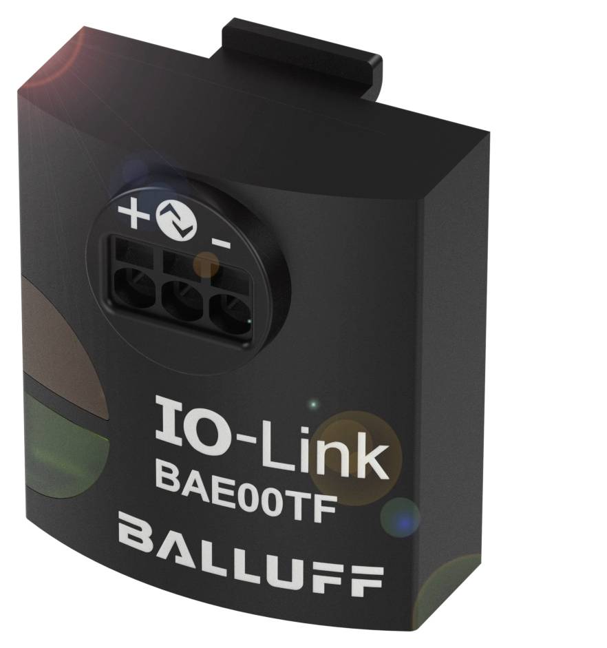 Čierne, obdĺžnikové elektrické zariadenie s nápisom 'IO-Link BAE00TF BALLUFF'. Hore sú viditeľné kladný a záporný pól.